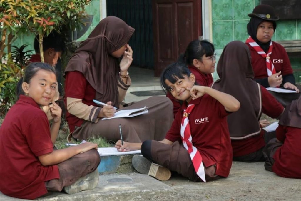 Students taking notes outdoors