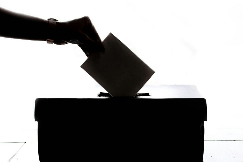 Casting a vote into a ballot box